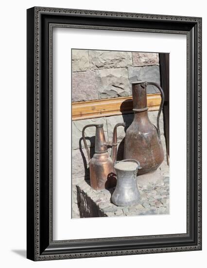 Azerbaijan, Lahic. A copper kettle and jug sitting outside a residence.-Alida Latham-Framed Photographic Print