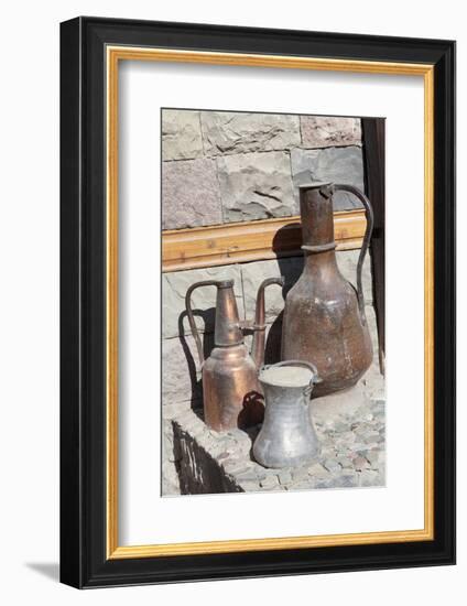 Azerbaijan, Lahic. A copper kettle and jug sitting outside a residence.-Alida Latham-Framed Photographic Print