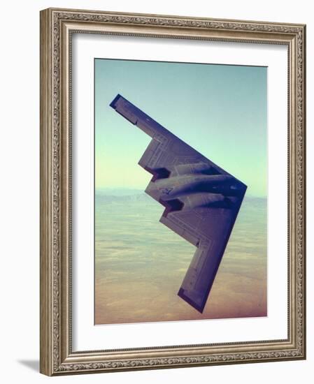 B-2 Stealth Bomber Flying over Desert-Like Landscape-null-Framed Photographic Print