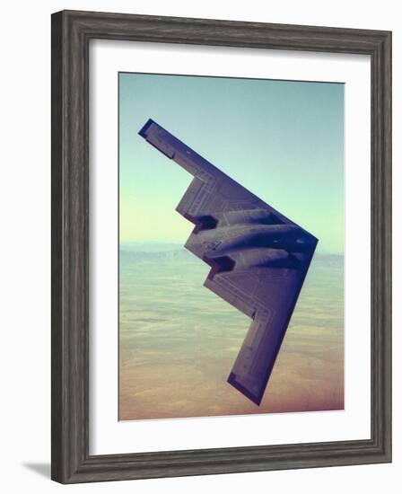 B-2 Stealth Bomber Flying over Desert-Like Landscape-null-Framed Photographic Print