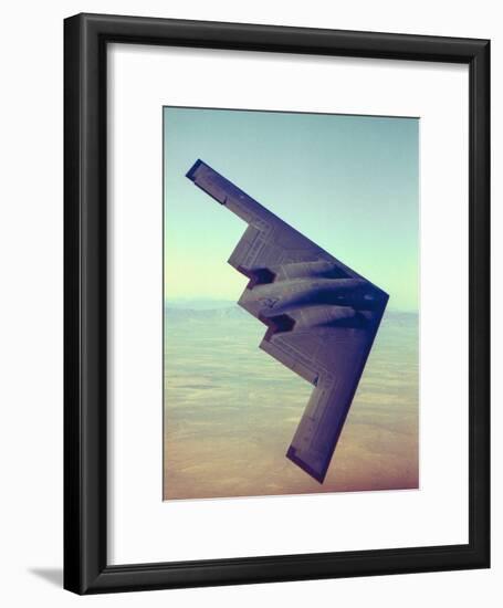 B-2 Stealth Bomber Flying over Desert-Like Landscape-null-Framed Photographic Print