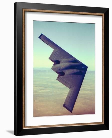 B-2 Stealth Bomber Flying over Desert-Like Landscape-null-Framed Photographic Print