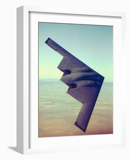 B-2 Stealth Bomber Flying over Desert-Like Landscape-null-Framed Photographic Print