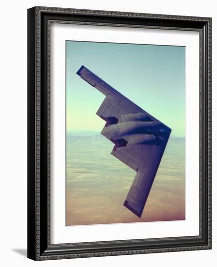 B-2 Stealth Bomber Flying over Desert-Like Landscape-null-Framed Photographic Print