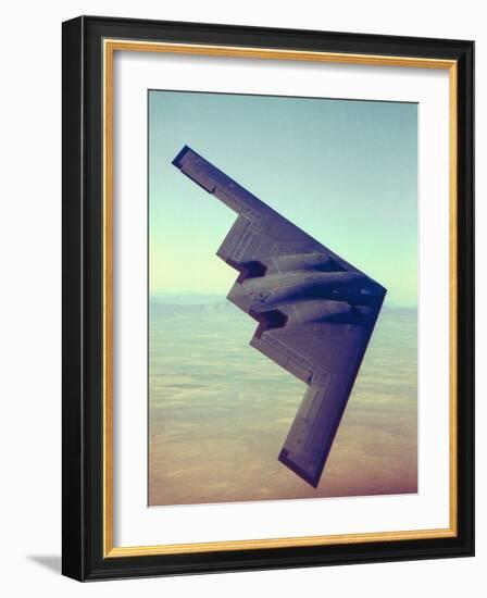 B-2 Stealth Bomber Flying over Desert-Like Landscape-null-Framed Photographic Print