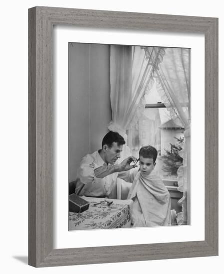 B.F. Goodrich Engineer Frank Herzegh Developed the Tubeless Tire, Cutting his son Frankie's hair-Alfred Eisenstaedt-Framed Photographic Print