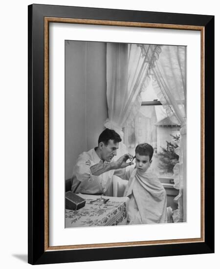 B.F. Goodrich Engineer Frank Herzegh Developed the Tubeless Tire, Cutting his son Frankie's hair-Alfred Eisenstaedt-Framed Photographic Print