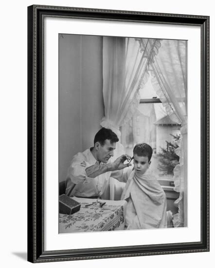 B.F. Goodrich Engineer Frank Herzegh Developed the Tubeless Tire, Cutting his son Frankie's hair-Alfred Eisenstaedt-Framed Photographic Print