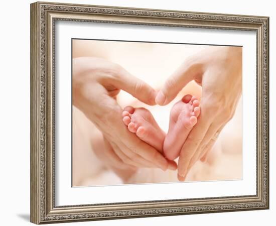 Baby Feet in Mother Hands. Tiny Newborn Baby's Feet on Female Heart Shaped Hands Closeup. Mom and H-Subbotina Anna-Framed Photographic Print