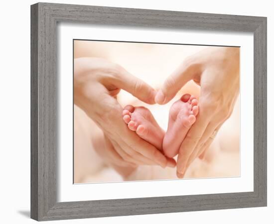 Baby Feet in Mother Hands. Tiny Newborn Baby's Feet on Female Heart Shaped Hands Closeup. Mom and H-Subbotina Anna-Framed Photographic Print