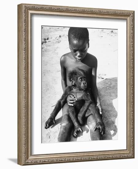 Baby Gorilla Named Bobo is Being Held by a Local Youngster-Eliot Elisofon-Framed Photographic Print