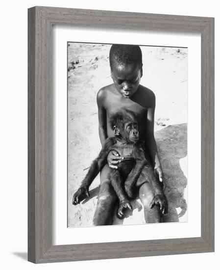 Baby Gorilla Named Bobo is Being Held by a Local Youngster-Eliot Elisofon-Framed Photographic Print