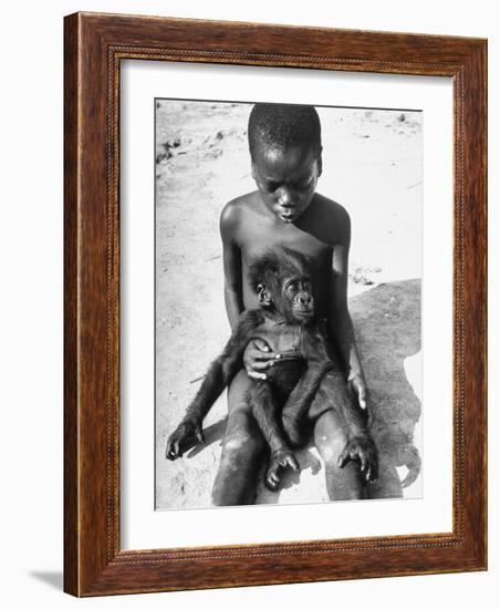 Baby Gorilla Named Bobo is Being Held by a Local Youngster-Eliot Elisofon-Framed Photographic Print