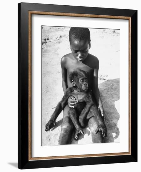 Baby Gorilla Named Bobo is Being Held by a Local Youngster-Eliot Elisofon-Framed Photographic Print