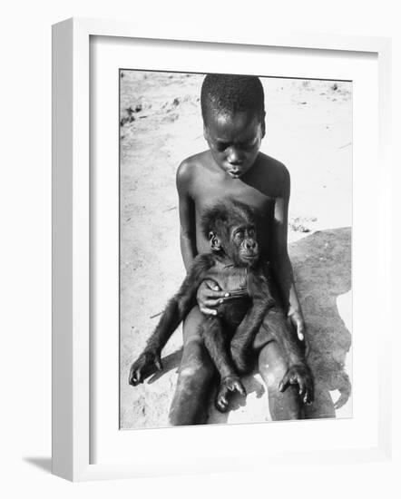 Baby Gorilla Named Bobo is Being Held by a Local Youngster-Eliot Elisofon-Framed Photographic Print