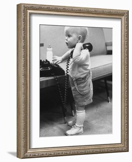 Baby Playing with a Telephone-Yale Joel-Framed Photographic Print