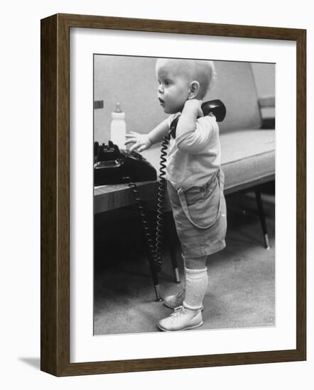 Baby Playing with a Telephone-Yale Joel-Framed Photographic Print