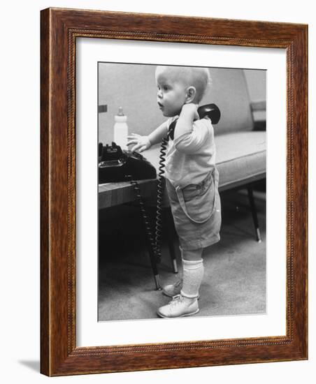 Baby Playing with a Telephone-Yale Joel-Framed Photographic Print