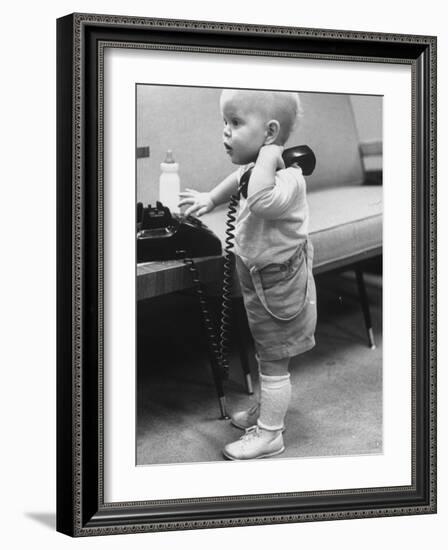 Baby Playing with a Telephone-Yale Joel-Framed Photographic Print