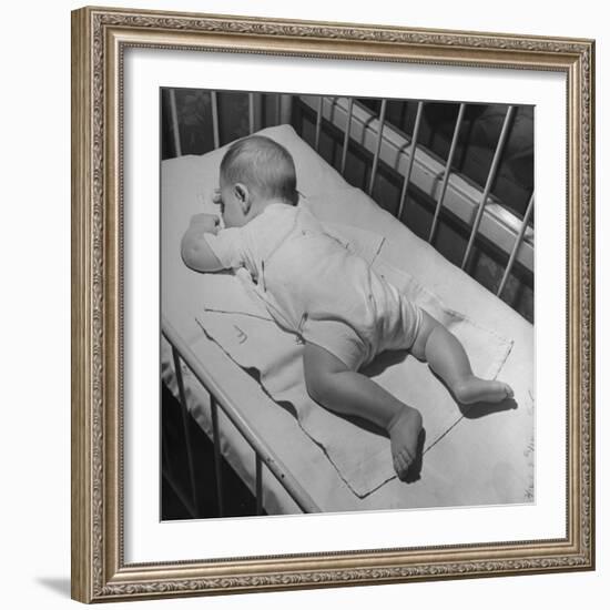 Baby Sleeping on its Stomach in Nursery at St. Vincent's Hospital-Nina Leen-Framed Photographic Print