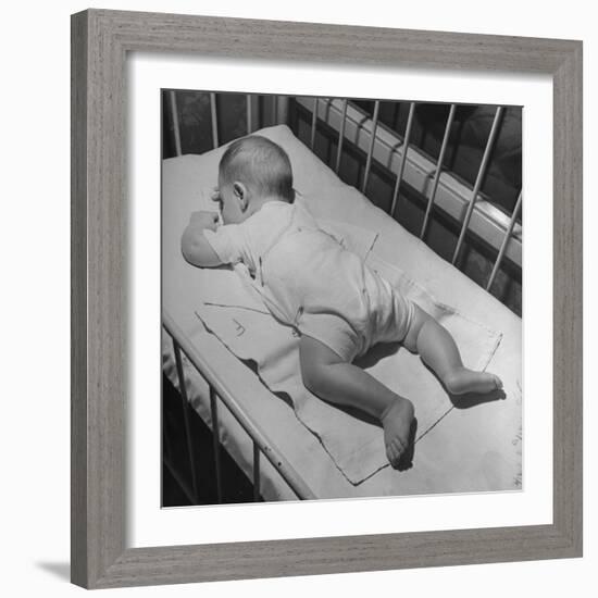 Baby Sleeping on its Stomach in Nursery at St. Vincent's Hospital-Nina Leen-Framed Photographic Print