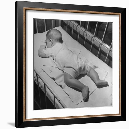 Baby Sleeping on its Stomach in Nursery at St. Vincent's Hospital-Nina Leen-Framed Photographic Print