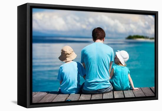 Back View of Father and Kids Sitting on Wooden Dock Looking to Ocean-BlueOrange Studio-Framed Premier Image Canvas