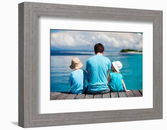 Back View of Father and Kids Sitting on Wooden Dock Looking to Ocean-BlueOrange Studio-Framed Photographic Print