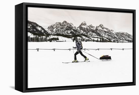 Backcountry skier under the Tetons, Grand Teton National Park, Wyoming, USA-Russ Bishop-Framed Premier Image Canvas