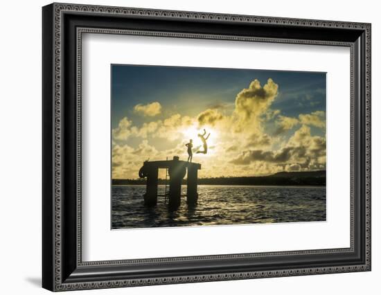 Backlit local boys jumping into the water of the lagoon of Wallis from a platform, Wallis and Futun-Michael Runkel-Framed Photographic Print