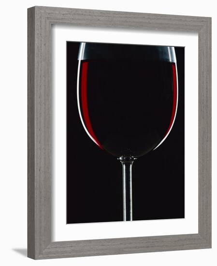 Backlit Shot of a Glass of Red Wine-Lee Frost-Framed Photographic Print