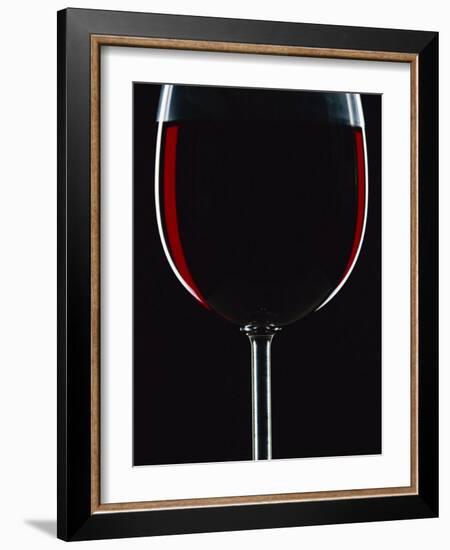 Backlit Shot of a Glass of Red Wine-Lee Frost-Framed Photographic Print