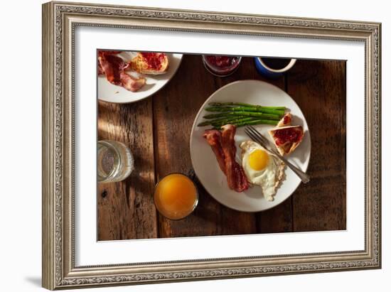 Bacon, A Sunny Side Up Egg, Pan Grilled Asparagus And Toast With Raspberry Jam On Wooden Farmtable-Shea Evans-Framed Photographic Print