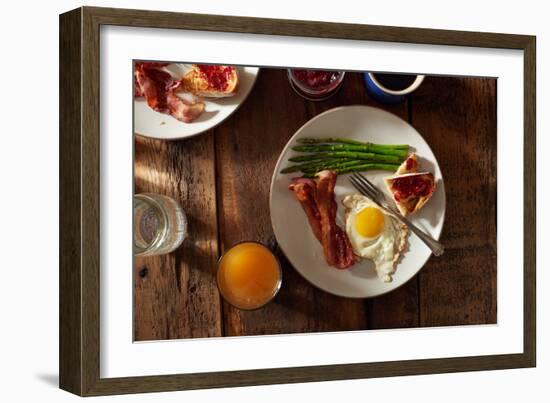 Bacon, A Sunny Side Up Egg, Pan Grilled Asparagus And Toast With Raspberry Jam On Wooden Farmtable-Shea Evans-Framed Photographic Print