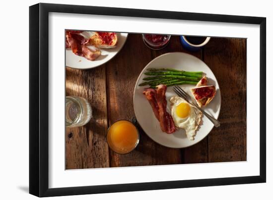 Bacon, A Sunny Side Up Egg, Pan Grilled Asparagus And Toast With Raspberry Jam On Wooden Farmtable-Shea Evans-Framed Photographic Print