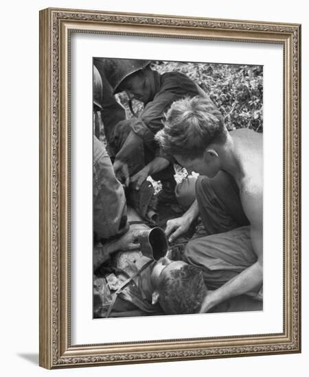 Badly Wounded Medic Being Given Water While Soldier in Background Cuts Clothing from His Wounds-null-Framed Photographic Print