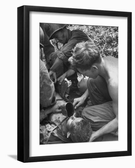 Badly Wounded Medic Being Given Water While Soldier in Background Cuts Clothing from His Wounds-null-Framed Photographic Print