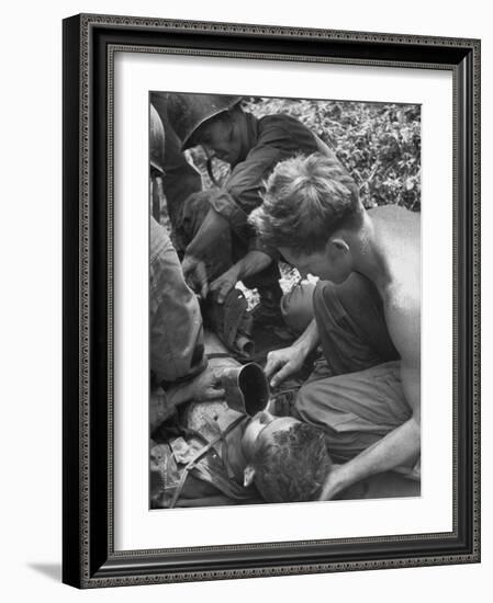 Badly Wounded Medic Being Given Water While Soldier in Background Cuts Clothing from His Wounds-null-Framed Photographic Print