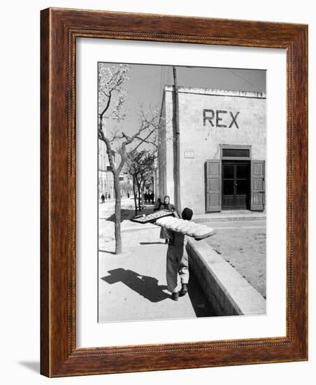 Baker's Apprentice Carrying a Large Tray of Bread Dough-Alfred Eisenstaedt-Framed Photographic Print