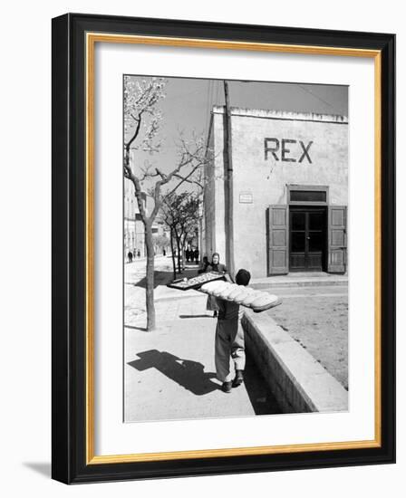 Baker's Apprentice Carrying a Large Tray of Bread Dough-Alfred Eisenstaedt-Framed Photographic Print