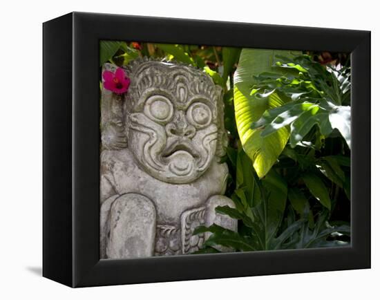 Bali, Ubud, a Stone Carving, Adorned with a Hibiscus Flower, Sits in Tropical Gardens-Niels Van Gijn-Framed Premier Image Canvas
