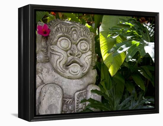 Bali, Ubud, a Stone Carving, Adorned with a Hibiscus Flower, Sits in Tropical Gardens-Niels Van Gijn-Framed Premier Image Canvas