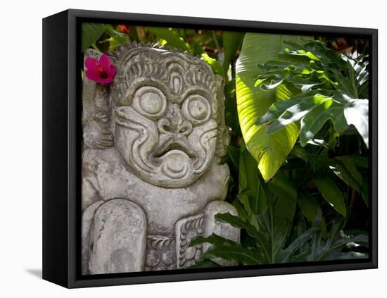 Bali, Ubud, a Stone Carving, Adorned with a Hibiscus Flower, Sits in Tropical Gardens-Niels Van Gijn-Framed Premier Image Canvas