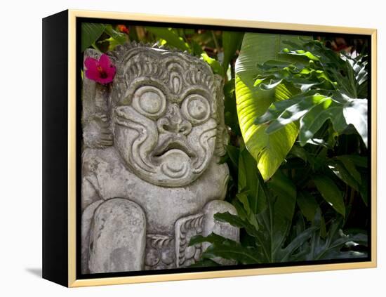 Bali, Ubud, a Stone Carving, Adorned with a Hibiscus Flower, Sits in Tropical Gardens-Niels Van Gijn-Framed Premier Image Canvas