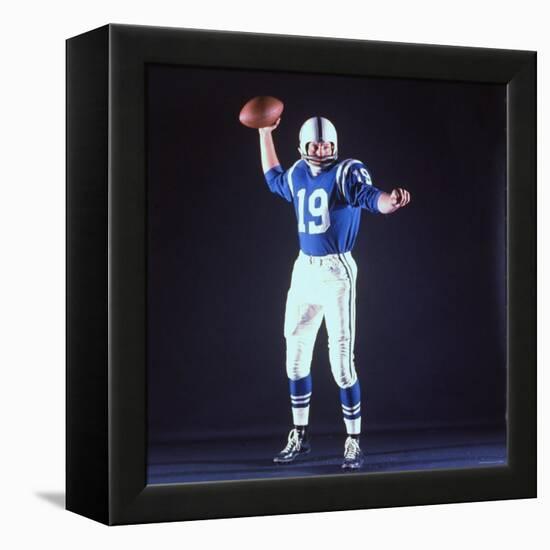 Baltimore Colts Football Player Johnny Unitas in Uniform While Holding Ball in Passing Stance-Yale Joel-Framed Premier Image Canvas