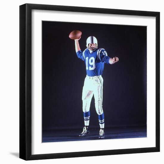 Baltimore Colts Football Player Johnny Unitas in Uniform While Holding Ball in Passing Stance-Yale Joel-Framed Premium Photographic Print