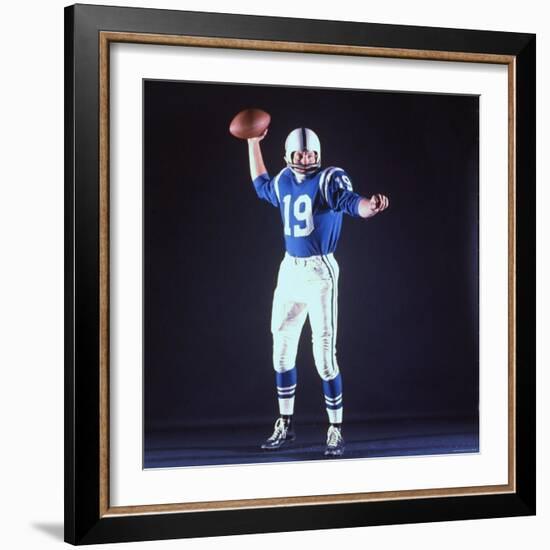 Baltimore Colts Football Player Johnny Unitas in Uniform While Holding Ball in Passing Stance-Yale Joel-Framed Premium Photographic Print