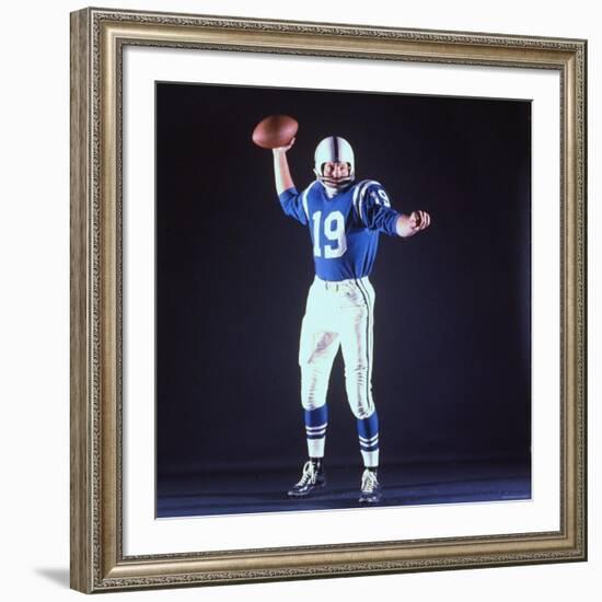 Baltimore Colts Football Player Johnny Unitas in Uniform While Holding Ball in Passing Stance-Yale Joel-Framed Premium Photographic Print