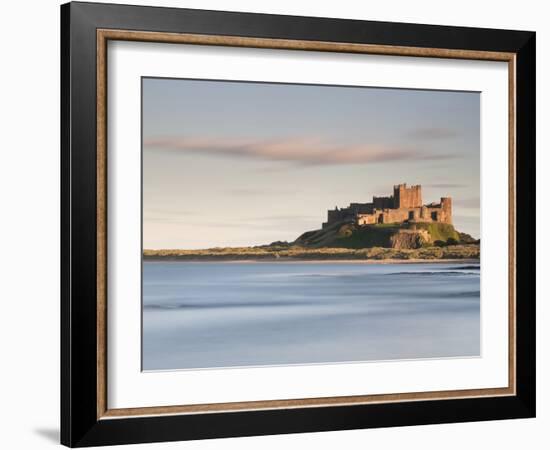 Bamburgh Castle Bathed in Golden Evening Light Overlooking Bamburgh Bay with the Sea Filling the Fo-Lee Frost-Framed Photographic Print