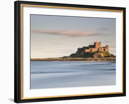 Bamburgh Castle Bathed in Golden Evening Light Overlooking Bamburgh Bay with the Sea Filling the Fo-Lee Frost-Framed Photographic Print